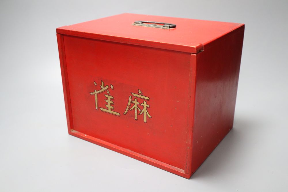 A Mah Jong set in red stained wood case